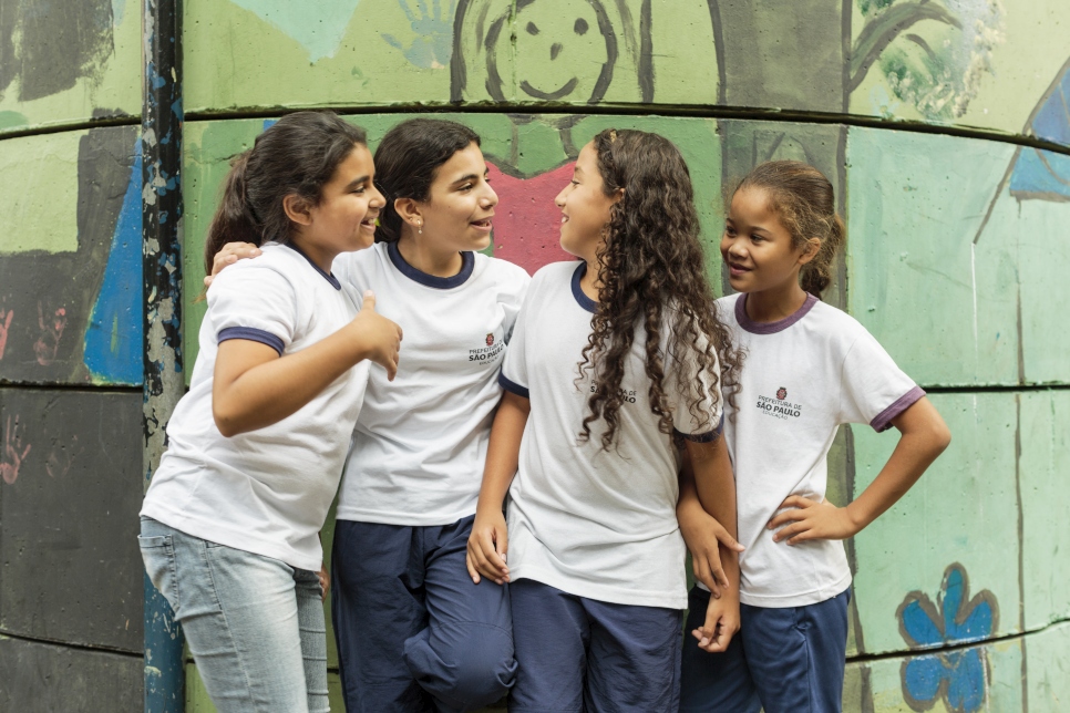 Syrian refugee Hanan Dacka, 12 years-old (2nd from left), plays with newly-made Brazilian friends (left - right) Julia Vanderlei, 12, Andessa Rabasco, 12, and Maria Luiza Sousa, 12, outside their classroom at the Duque de Caxias Municipal School in the Glicerio neighborhood of downtown Sao Paulo in Brazil.