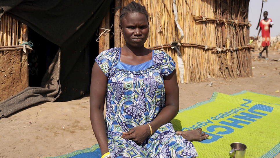 South Sudanese returnee, widow, and mother of four, Mary Nyekuola, sits outside a shelter in Bentiu.