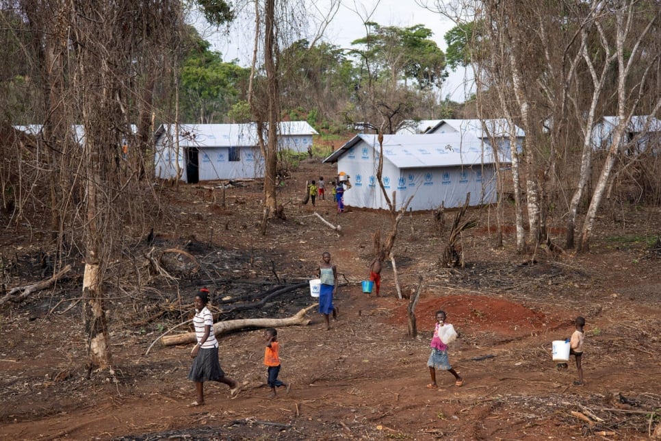 People walk within a section of Modale site in northern Democratic Republic of the Congo, where UNHCR is relocating Central African refugees from the border area. 