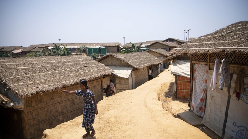 Myshara stands outside her family's home in Kutupalong camp. 