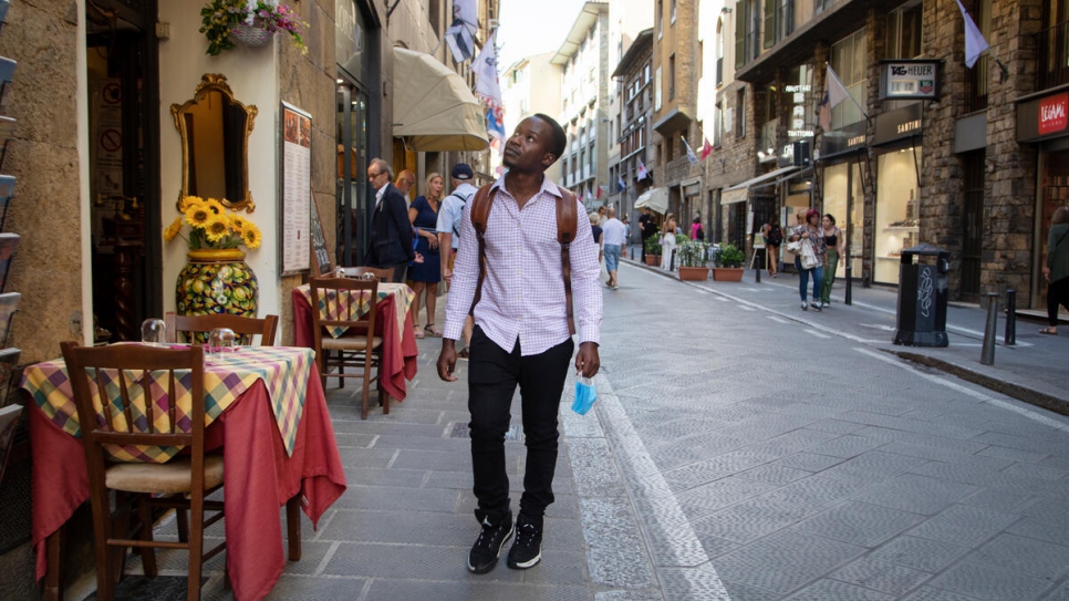 Jules walks through the city of Florence towards the university campus. 