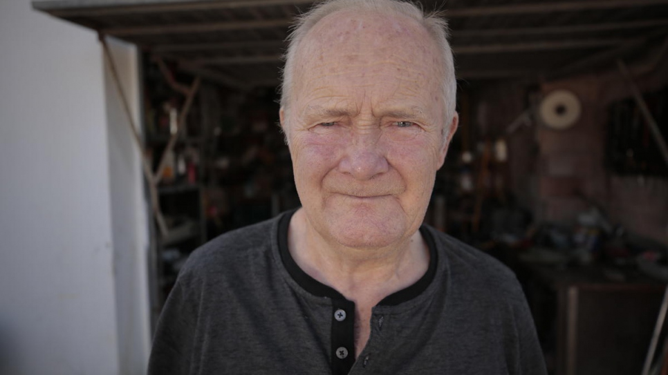 Sergio Chekaloff, 74, stands in front of the workshop of the construction company his sons founded in Ibiza, Spain.