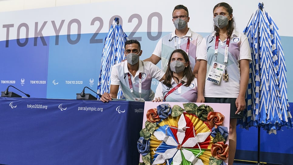 Members of the Refugee Paralympic Team stand with more than 3,000 paper airplanes during a press conference ahead of the Tokyo 2020 Paralympic Games. 