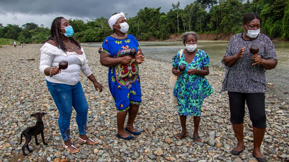 Tía Gachita members play traditional 'arrullo' rhythms from the Ecuadorian and Colombian Pacific region on a riverbank near the community of Calderón, Ecuador.