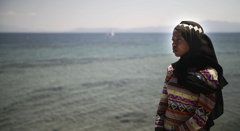 Emi looks out over the sea towards Turkey. Over one million refugees crossed the Mediterranean Sea in the year preceding Emi's visit. 