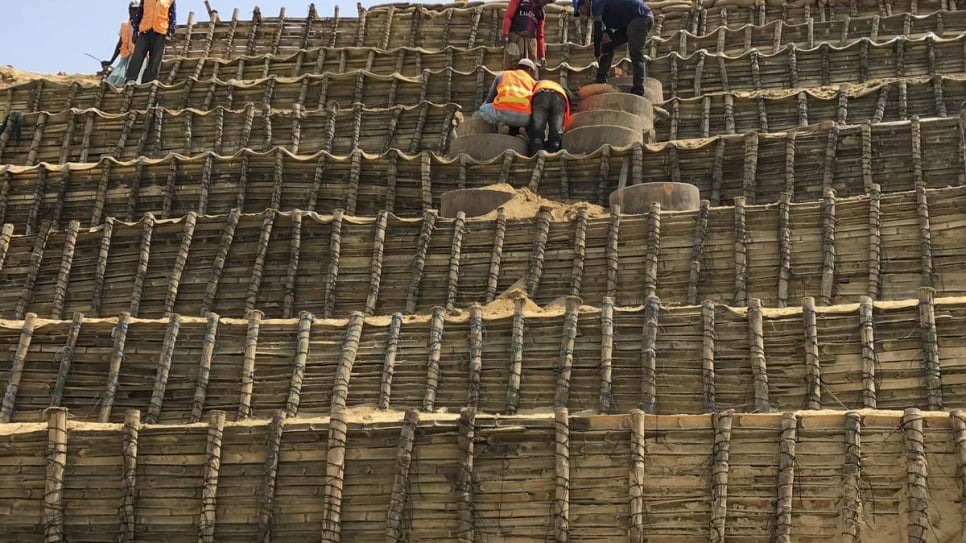 A Site Maintenance Engineering Project team stabilises slopes at Chakmarkul settlement, home to some 13,000 Rohingya refugees living on steep hills.