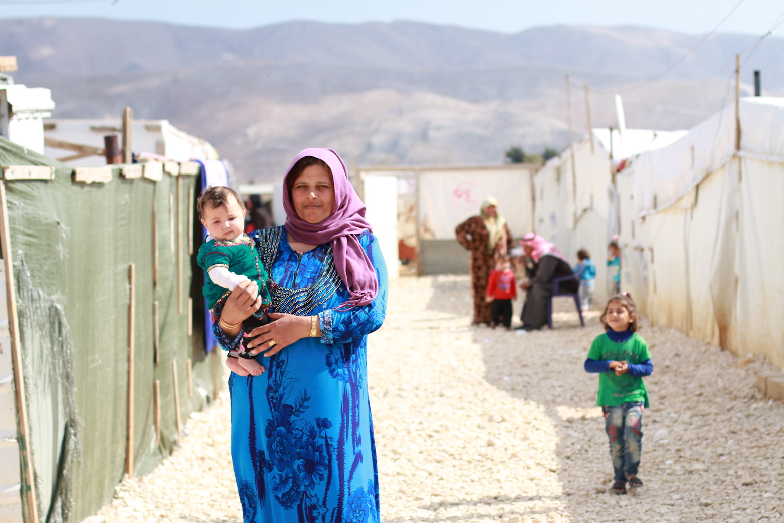 A refugee woman holds her child in an informal settlement in the town of Dalhamiye in Lebanon’s Bekaa. The informal settlement, situated between Mount Lebanon to the West and the Anti-Lebanon Mountains to the East, is home to 70 Syrian families most of whom are originally from Homs.