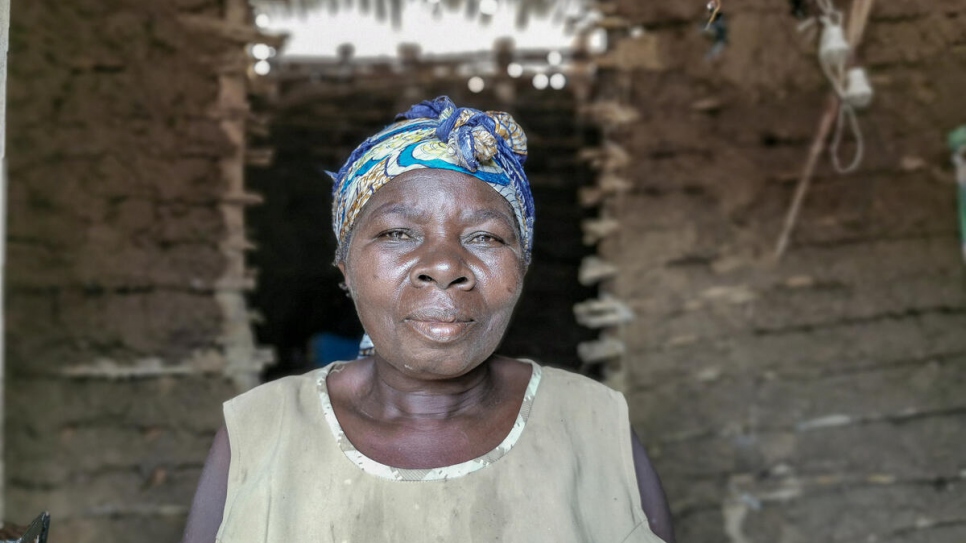 Kahambu Mwavuli, 57, stands inside one of the houses in her compound where she accommodates 25 people in Beni, in north-eastern Democratic Republic of the Congo.  