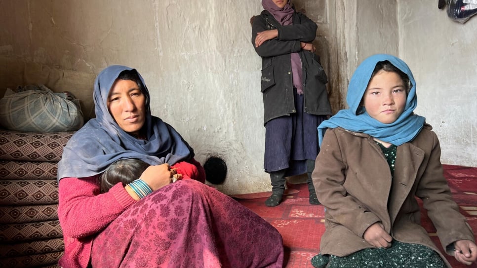 Mother of six, Nekhbakhd, with her three daughters, who collect animal manure to burn in the stove so the family can stay warm.