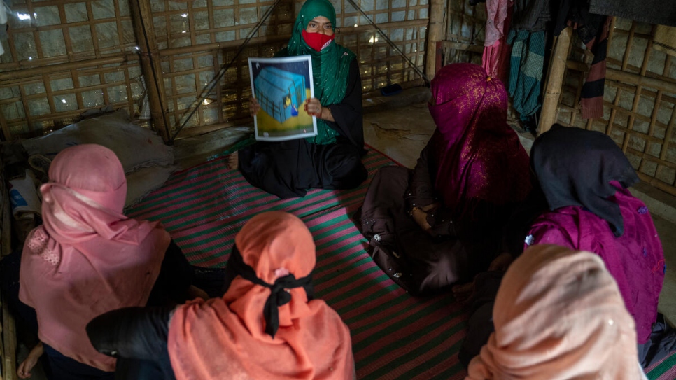 Beauty runs an awareness-raising session with other Rohingya women. 