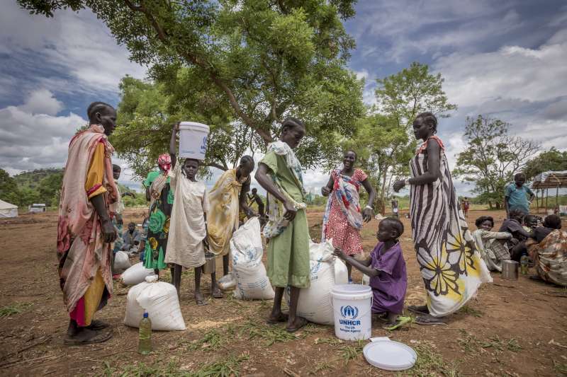 Ethiopia/ South Sudanese refugees/ food distribution. WFP is distributing food to refugees from South Sudan in Kule 1 refugee camp. After repacking the refugees bring their food items to their homes in the refugee camp in Kule 1. As the conflict in South Sudan broke out in December 2013 many South Sudanese citizens crossed the border with Ethiopia. At the end of May Ethiopia is hosting more than 130.000 refugees from South Sudan. / UNHCR/ P.Wiggers/ May 2014