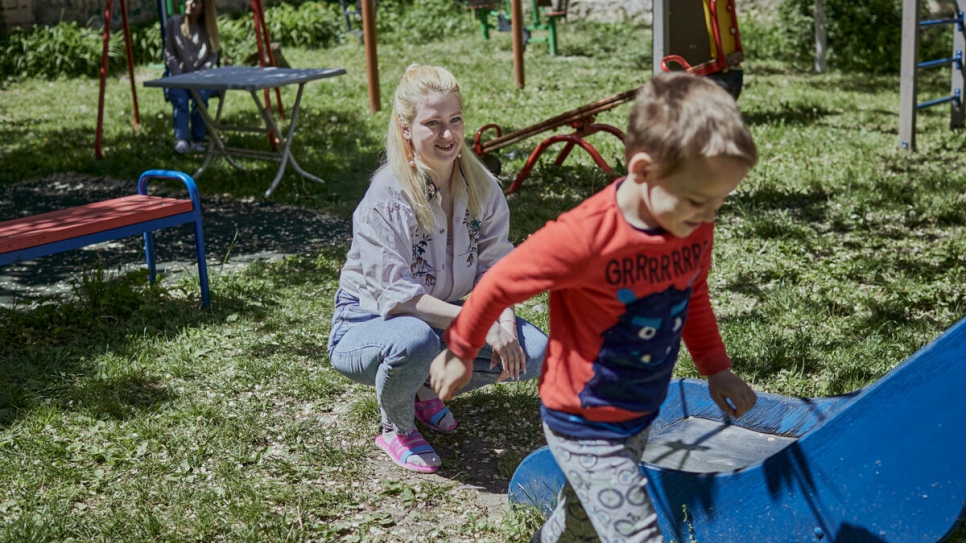 Vita watches her son play in the garden at Casa Marioarei. She fled Odesa to bring him to safety.