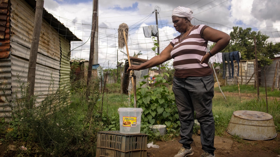 Bonisiwe collects water at a neighbour's tap in Mamelodi township near Pretoria, South Africa.