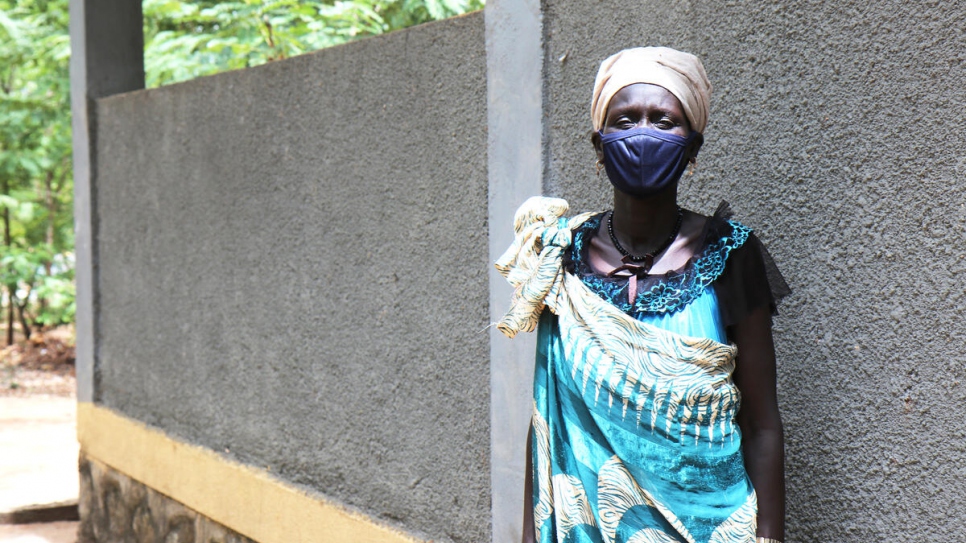 South Sudanese health worker Mary Nyabang, stands outside the health center in Jewi refugee camp, Ethiopia. 