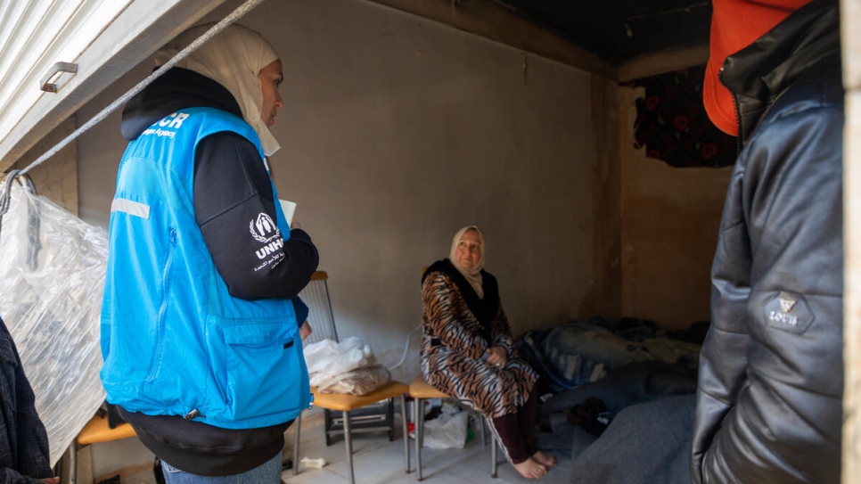 A UNHCR staff member meets a woman sheltering in the empty shops of Al-Harir souq in the Old City of Aleppo, Syria.
