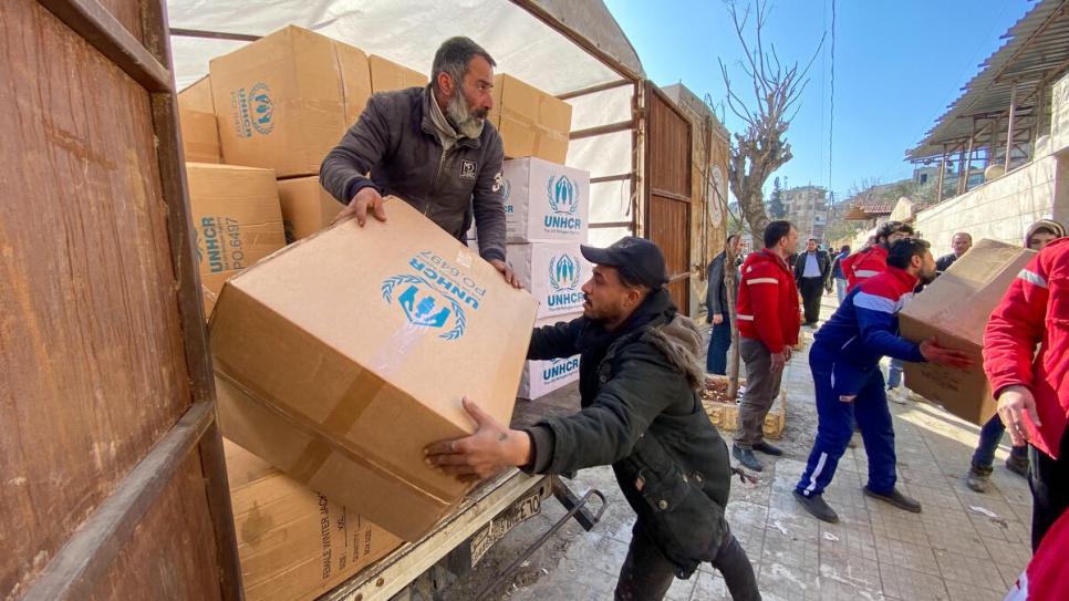 Relief items including high-thermal blankets and kitchen sets are unloaded for distribution at the mosque in the Suleiman Al-Halabi neighbourhood of Aleppo.