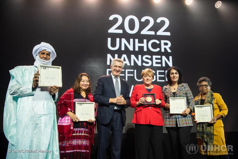 Former Federal Chancellor of Germany, Dr. Angela Merkel, the 2022 Nansen Refugee Award Global Laureate, and UN High Commissioner for Refugees Filippo Grandi, pose for a photograph with this year's Nansen Refugee Award Regional Winners.