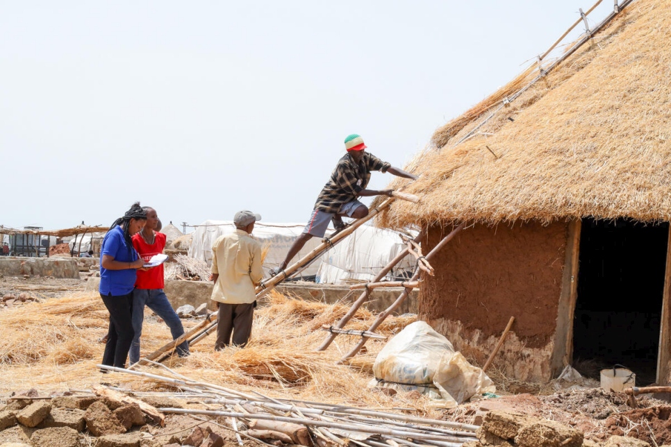 Sudan. Refugee civil engineers supervise shelter construction