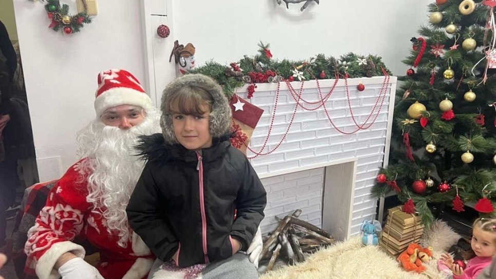 Ukrainian refugee Sofia meets Santa Claus during a Christmas Charity Bazaar at the hospital.