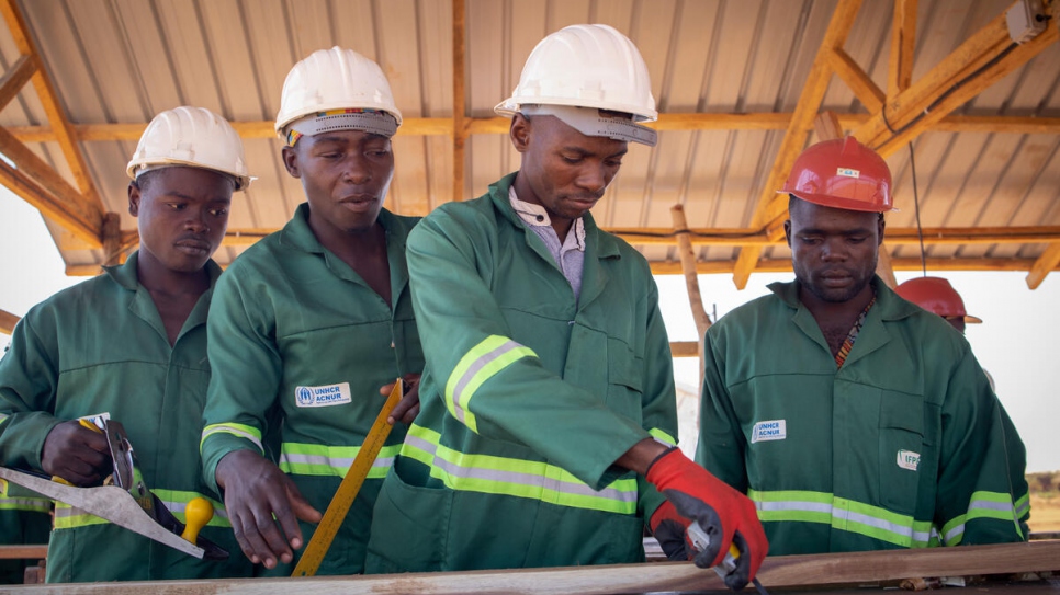 Internally displaced Mozambicans are taught how to make roofing planks to construct their own shelters in Corrane displacement site, Nampula Province, Mozambique.