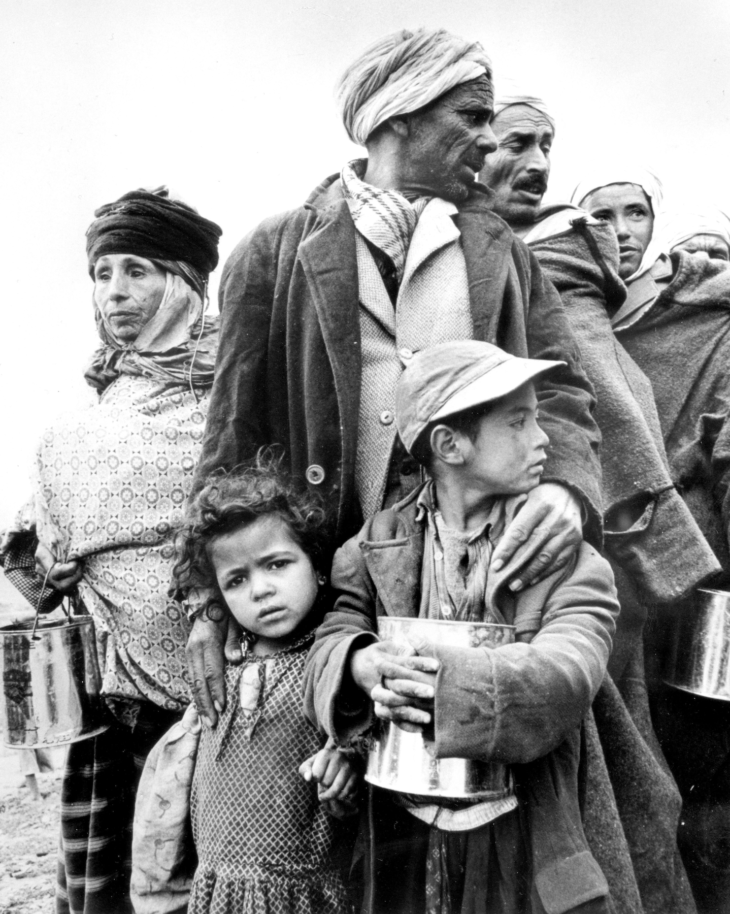 Algerian refugees gathered at Oued R'man near Le Kef in Tunisia for a distribution of food by the Red Crescent Society, 1959. Original Black and white picture