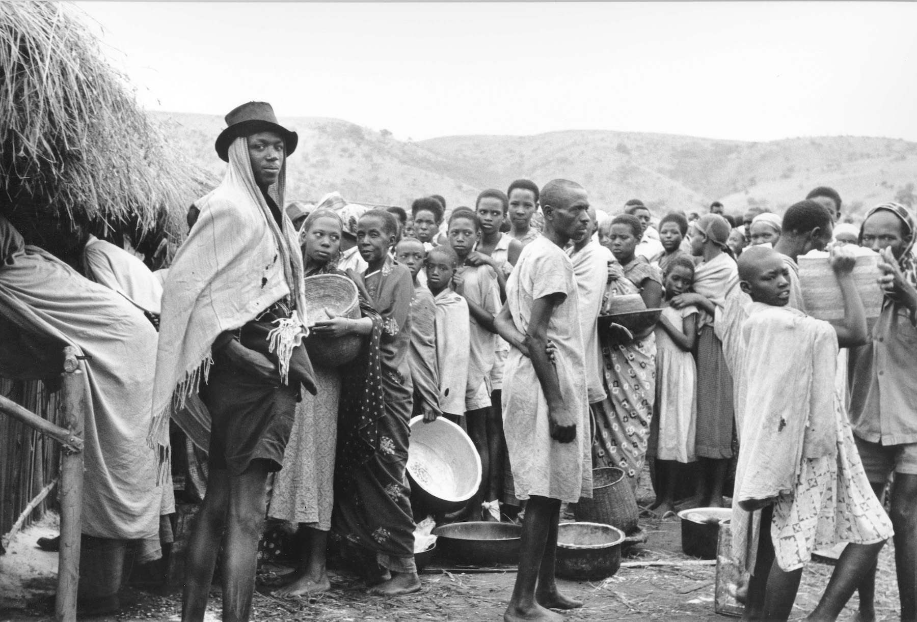 A group of Rwandese waiting for the distribution of food rations at a refugee centre in Uganda's Oruchinga Valley, 1964. Original Black and white picture