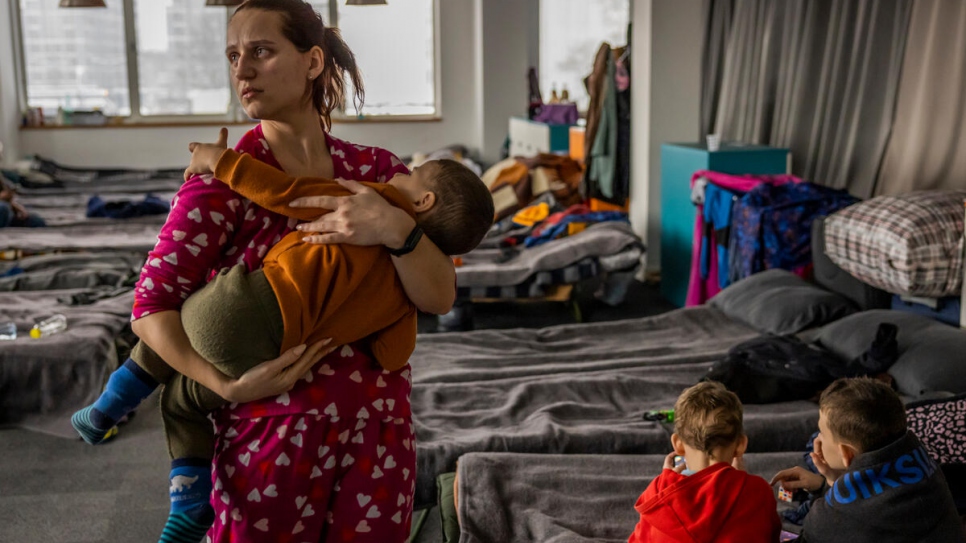 Kateryna holds her son Arsen, 2, at the shelter where she and her family live with 400 other refugees from Ukraine. Although her husband has found a job, they have not been able to find an apartment to rent.
