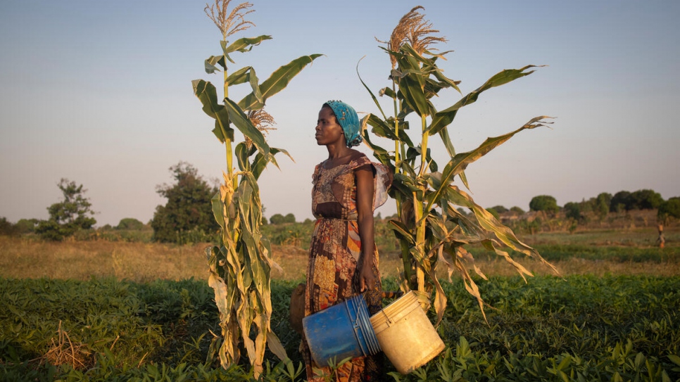 Dorotea gets ready to return home after watering her potato field. The money she makes from selling the potatoes is not enough to support her seven children.