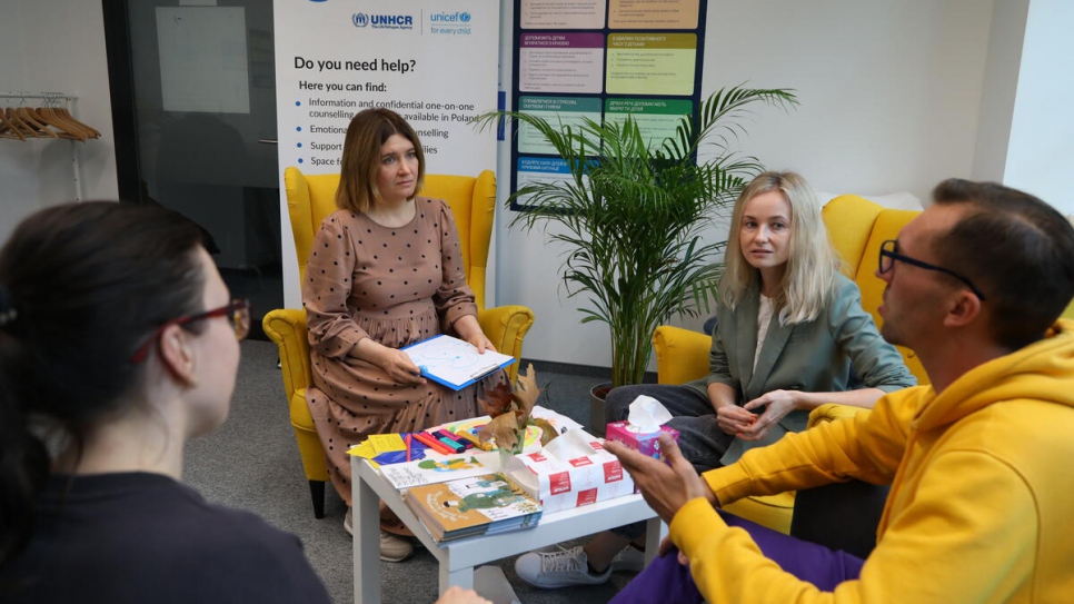 At a Blue Dot hub in Warsaw, Inna Chapko (second from the left) regularly receives refugees interested in therapy sessions and looking for information about psychosocial services.