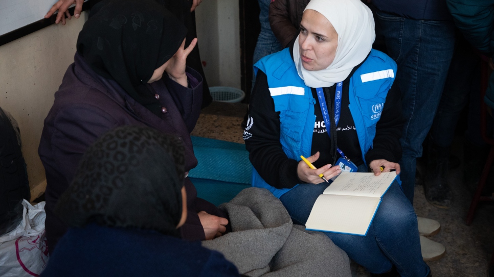 UNHCR staff meet families affected by the earthquake in a collective shelter in the Salahadin neighbourhood of Aleppo, Syria.