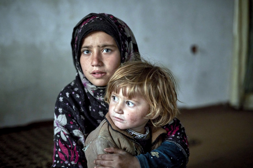 Two internally displaced sisters from Jalalabad pictured in their temporary accommodation in Kabul, Afghanistan. © UNHCR/Andrew McConnell