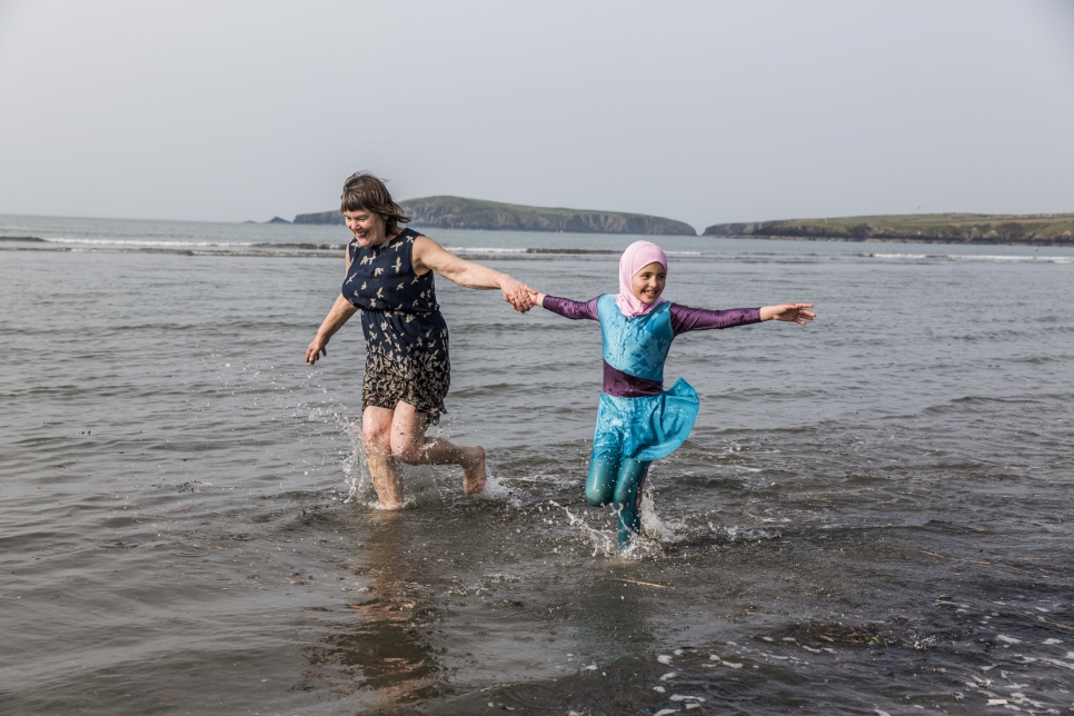 Amy Chapman plays with Adbul, 4, and Noor, 6, at the Arnout family home in Ottery St Mary, Devon, south-west England. Amy is a friend of the family and often drops by to help the children read English