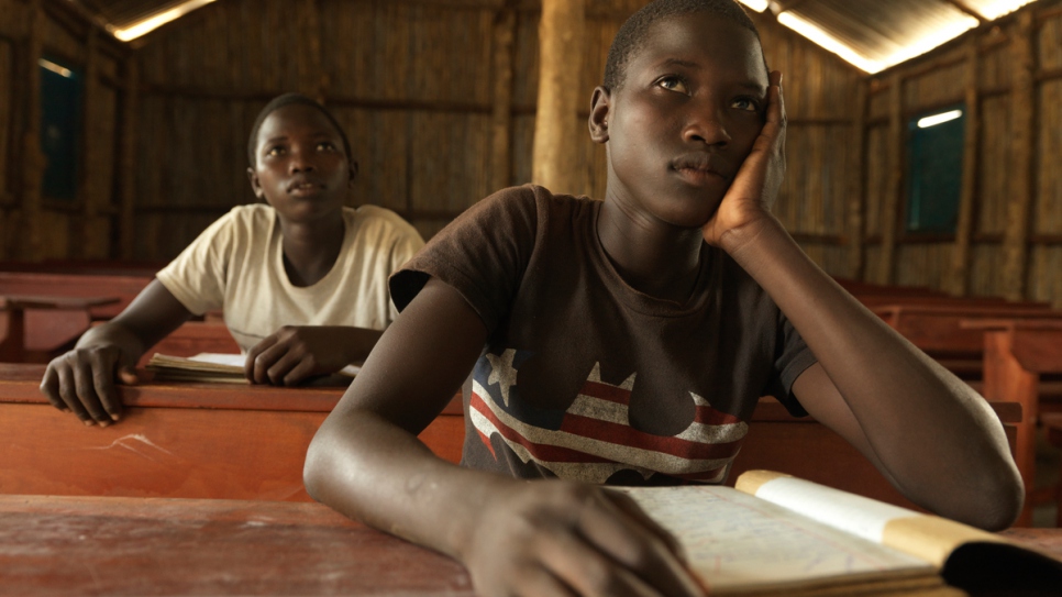 At a purpose-built UNHCR school, Tabu (right) and her twin sister Rena enjoy attending classes, though Tabu says it is overcrowded and she lacks school books.