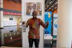 Malish Godfrey poses with hand-made products from South Sudan at the K...