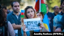 The crowd at the Baku rally held aloft Azerbaijani flags and photographs of people believed to be political prisoners.