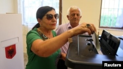 A woman casts her vote during parliamentary elections in Surel, near Tirana, on June 25.