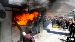 Protestors set fire to a toll booth during clashes with police on March 31 at a toll plaza on the Durres-Kukes Highway, linking Albania with Kosovo.