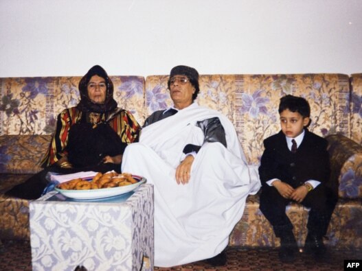 An undated photo shows Muammar Qaddafi during a family visit. The photo was found in a family album at his wrecked former headquarters at Tripoli's Bab al-Aziziya compound on August 28.