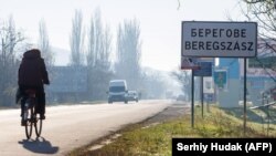 Inscriptions in two languages, Ukrainian and Hungarian, are seen on a road sign of Berehove, a small town in western Ukraine.
