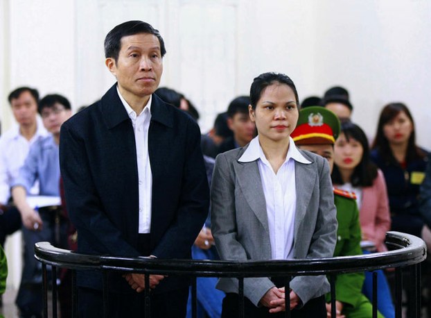 Vietnamese blogger Nguyen Huu Vinh (L), 60, and his assistant Nguyen Thi Minh Thuy (R), 35, stand trial in a court room at the local People's Court in Hanoi, March 23, 2016.
