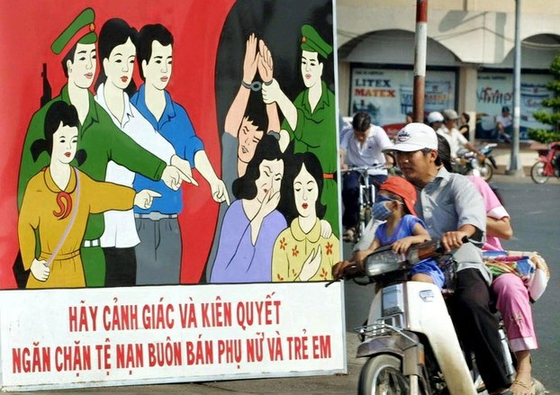 A file photo of a poster in a street in Ho Chi Minh City appealing to people to be vigilant against human trafficking.