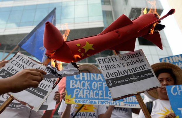Protesters in Manila denounce China's deployment of surface-to-air missile system on Woody Island, part of the Paracel Island chain that Vietnam and Taiwan also claim, Feb. 19, 2016.