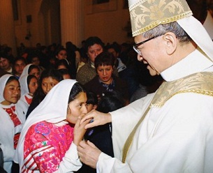 A woman kisses Cardinal Nguyen Van Thuan's hand in Chiapas, Mexico 30 Oct. 2001. 