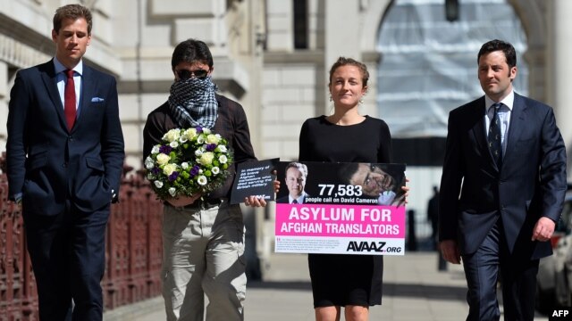Former British servicemen arrive with an interpreter named Mohammed (2nd left) at the Foreign and Commonwealth Office in London on May 3 to deliver a petition calling for asylum for Afghan interpreters who served the British Army.