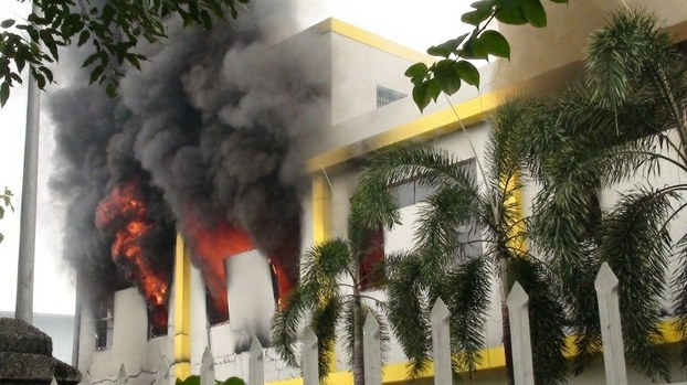 Smoke and flames billow from a factory window in Binh Duong province on May 14, 2014.