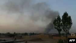 Smoke rises over the city of Ghazni after Taliban militants launched an attack on the Afghan provincial capital late on August 9.