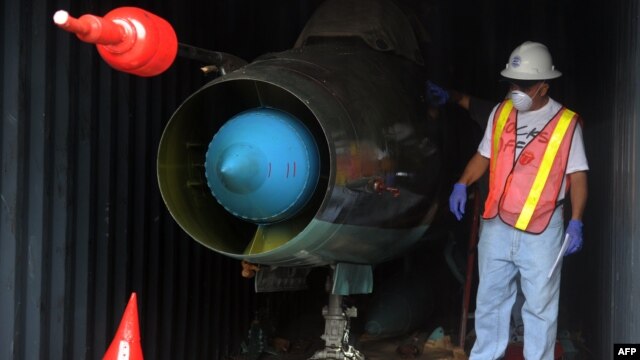 A man in Colon, Panama works in a container with a MiG-21 jet inside that was found on the North Korean vessel 'Chong Chon Gang.'