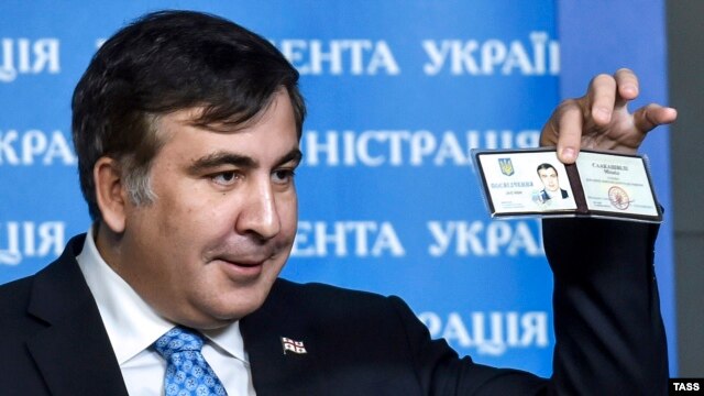 Former Georgian President Mikheil Saakashvili shows off his identification card as the head of an advisory council in Kyiv in February.