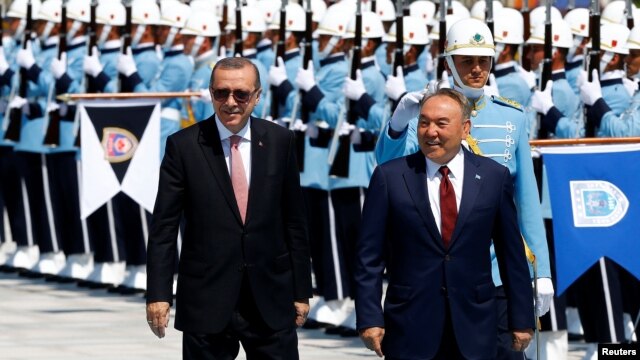 Turkish President Recep Tayyip Erdogan (left) and Kazakh President Nursultan Nazarbaev review an honor guard in Ankara on August 5.