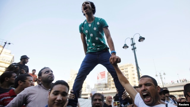 Supporters of the Muslim Brotherhood shout slogans against the military and Interior Ministry during a protest in front of the Al-Istkama Mosque on Giza Square, south of Cairo, on August 18.